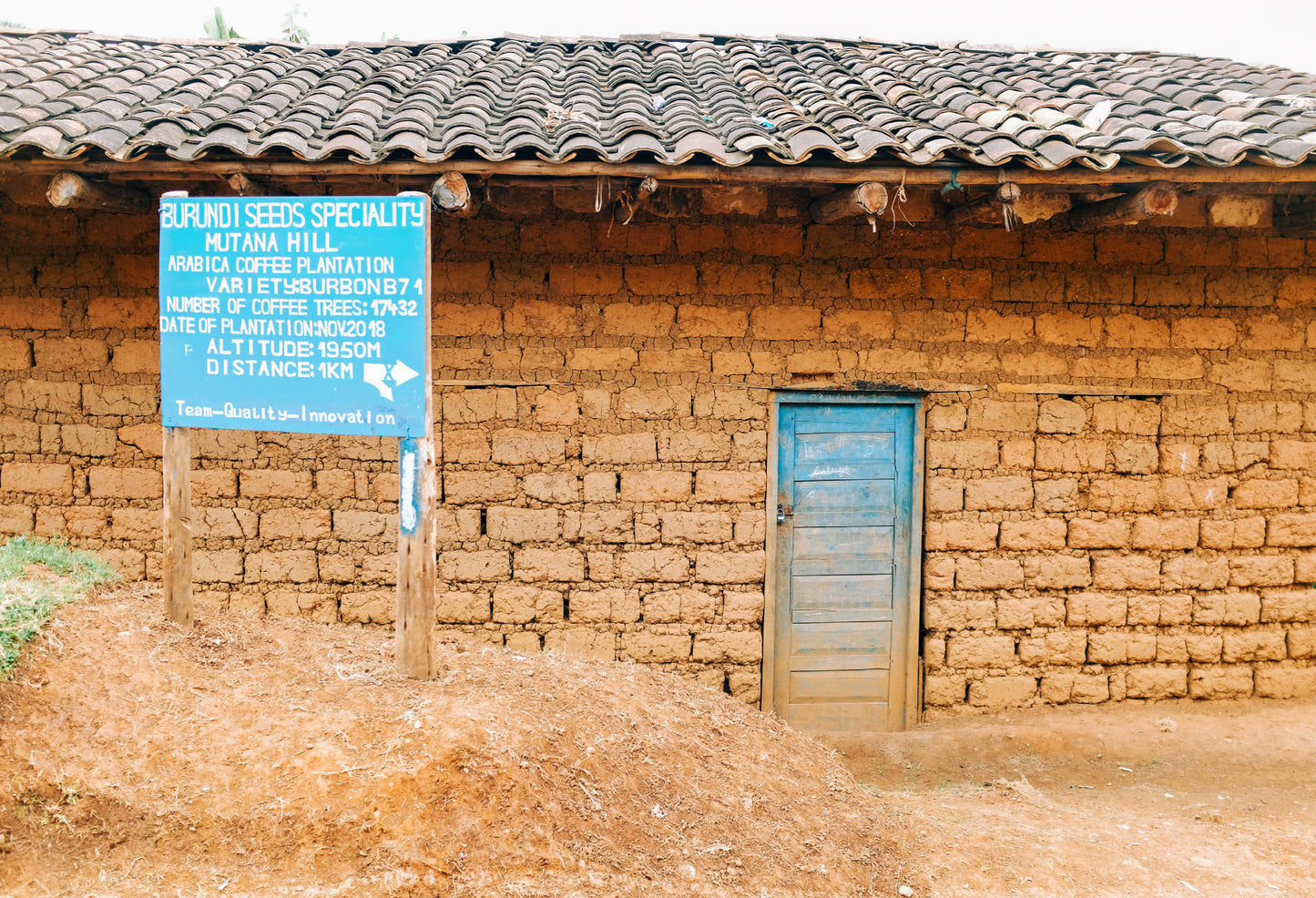 Brick building with a blue sign in an outdoor setting
